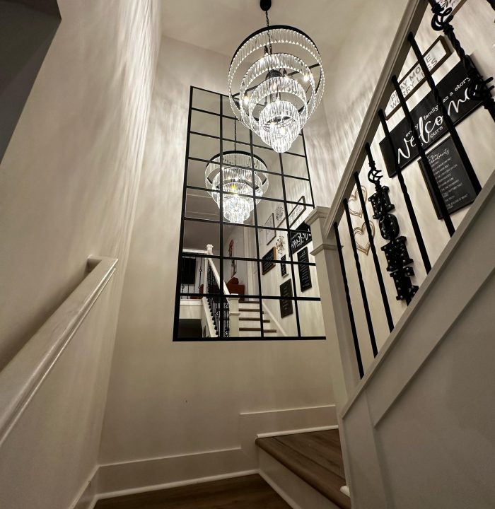 Accent wall with light fixture installed at the stairwell